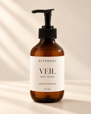 VEIL body serum Spiced Sandalwood in amberkleurige pompflacon op warme lichte achtergrond